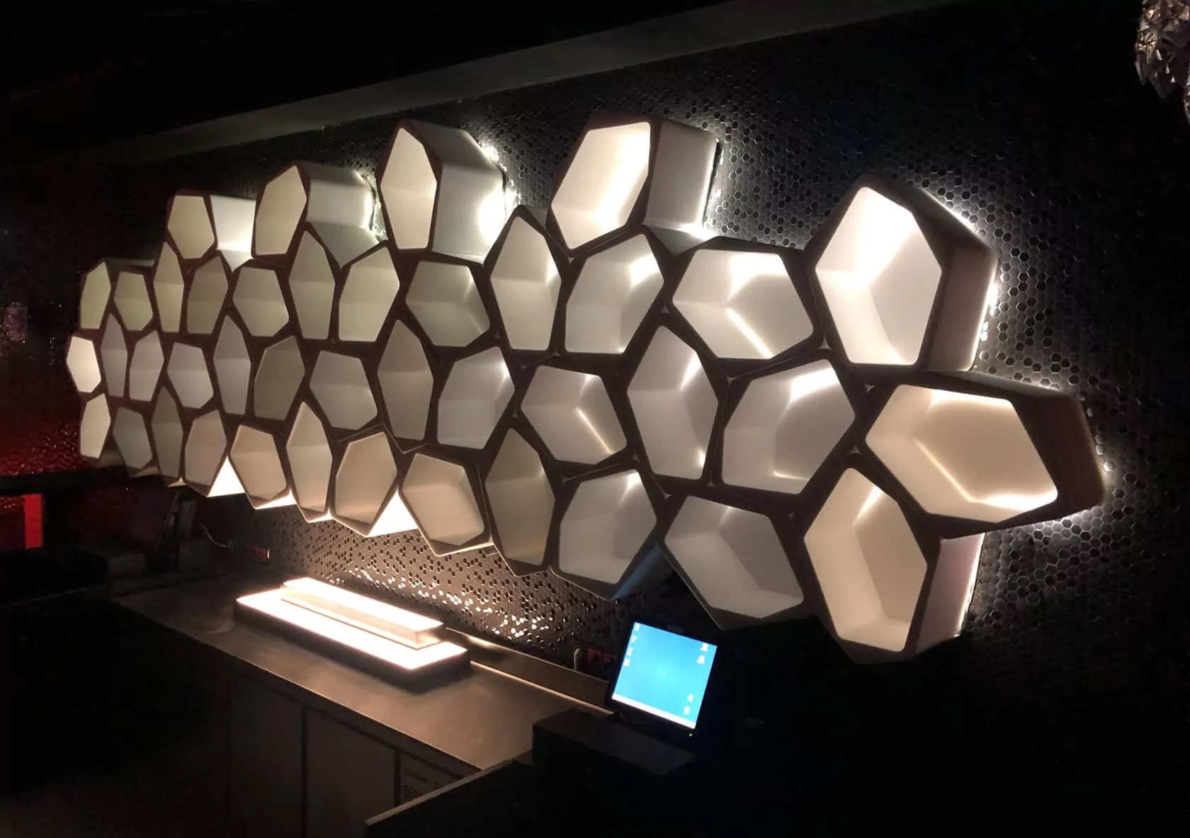 white floating wall shelves with LED backlighting at the BCM club