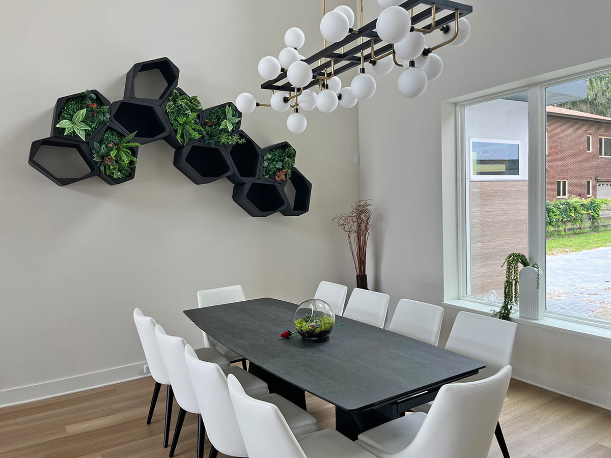 A stylish indoor plant wall shelf featuring black closed and open honeycomb shelves by Movisi