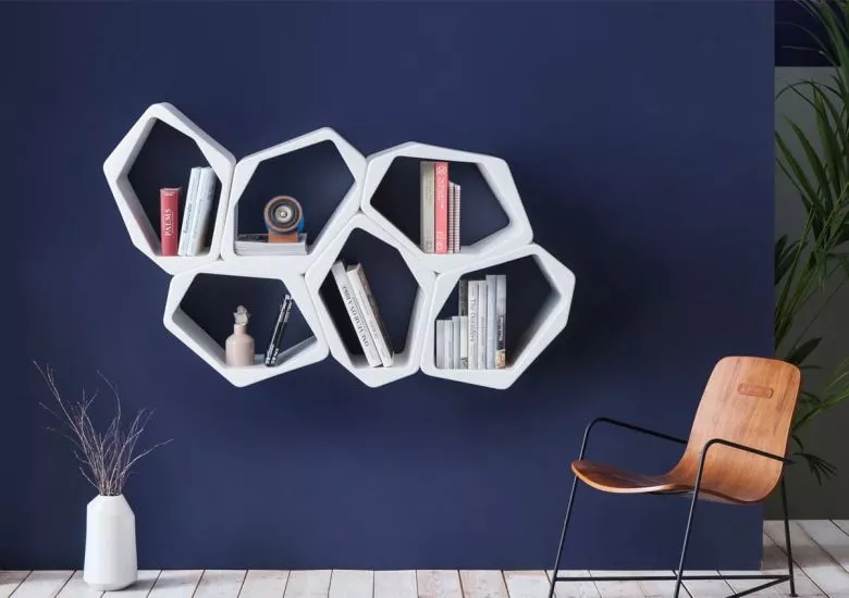 White modular wall shelves and hanging shelves on blue wall by Movisi modular furniture